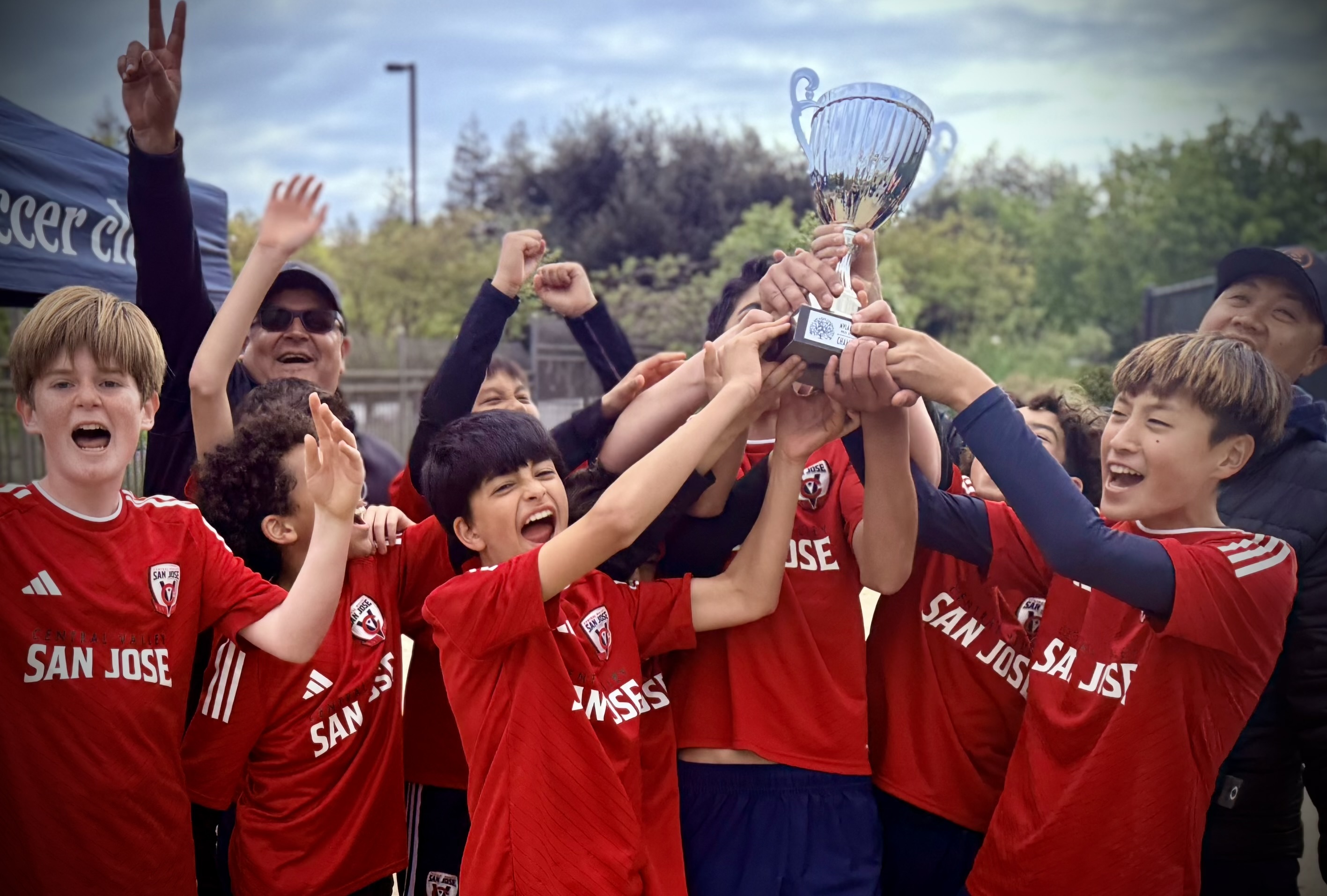 SPARTANS players celebrating a championship trophy